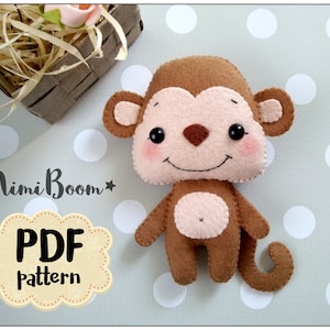 May include: A brown felt monkey toy with a pink face and a brown tail. The toy is on a white background with gray polka dots. The text "*MimiBoom* PDF pattern" is in the lower left corner of the image.