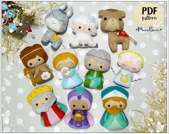 May include: A collection of felt Christmas nativity figures, including a donkey, sheep, camel, angel, and three wise men. The figures are in various colors, such as gray, brown, white, and blue. The image also includes the text "PDF pattern" and the MimiBoom logo.