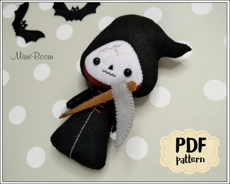 May include: A handmade felt Grim Reaper doll with a black hooded robe, a white skull face, and a gray scythe. The doll has black button eyes and a red collar. The image includes the text "MimiBoom" and "PDF Pattern".