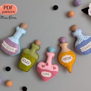 May include: Five felt potion bottles with different colours and labels. The labels read "Wisdom", "Power", "Love", "Fortune", and "Courage".