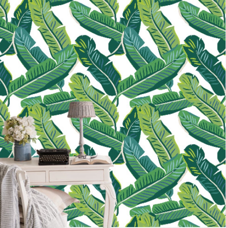 May include: A white background with a repeating pattern of green banana leaves. The leaves are stylized and have a graphic design.