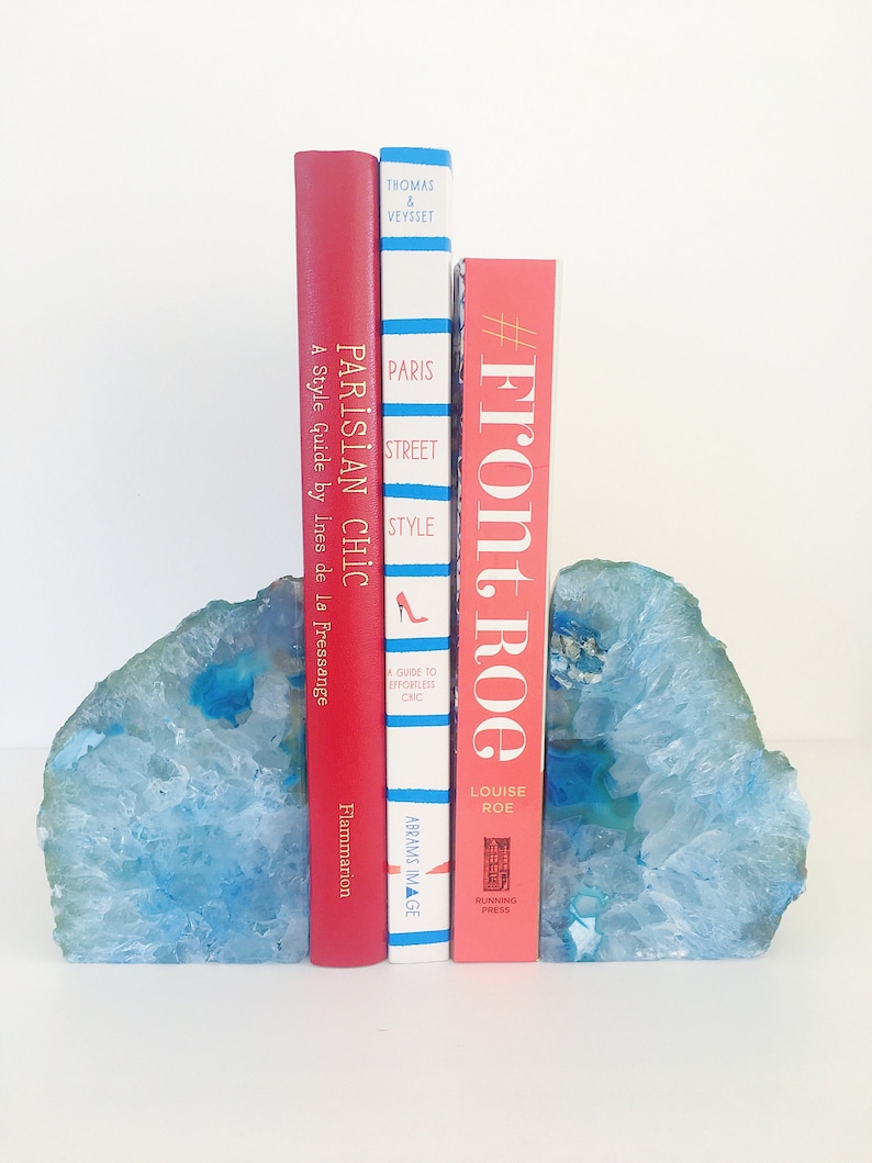 May include: A set of blue agate bookends holding up three books. The books are titled "Parisian Chic", "Paris Street Style", and "#Front Roe" by Louise Roe.