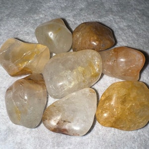 Golden Healer Quartz, S/M/L, Tumbled; Light, varies from translucent with golden color to dark brownish coloring