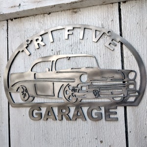 May include: Metal sign with a vintage car silhouette and the text "Tri-Five Garage".