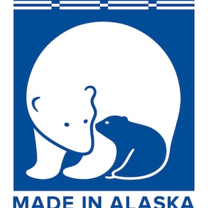 May include: A blue square with a white polar bear and cub inside. The text "MADE IN ALASKA" is below the image.