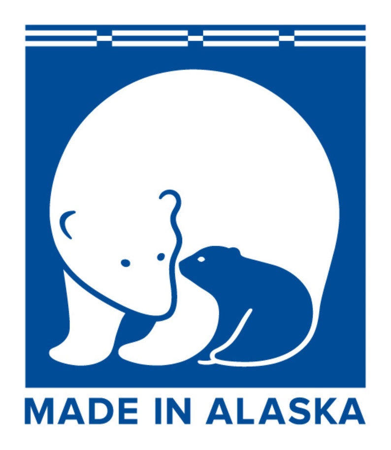 May include: A blue square with a white polar bear and cub inside. The text "MADE IN ALASKA" is below the image.