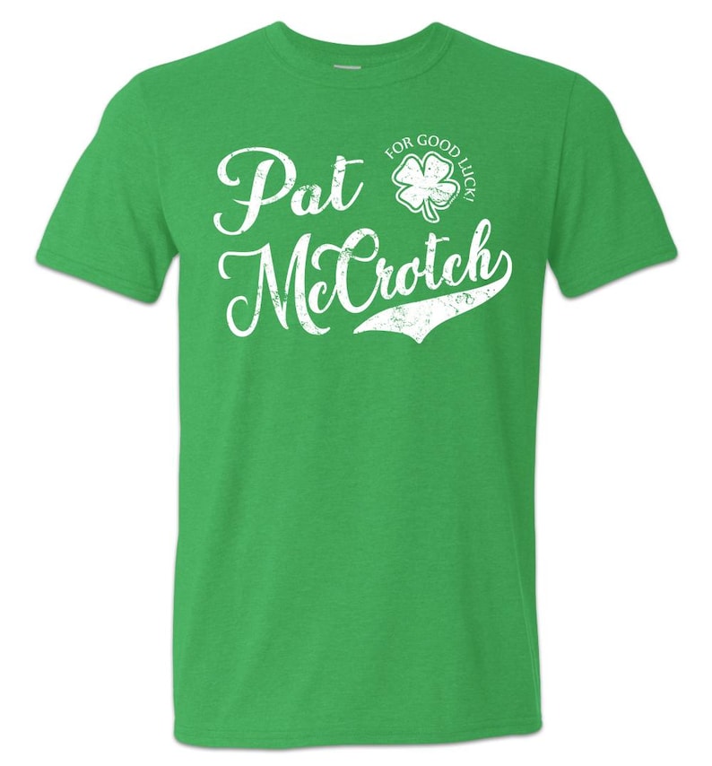 May include: Green t-shirt with a white distressed graphic that says "Pat McCrotich" with a four-leaf clover graphic that says "For Good Luck!"