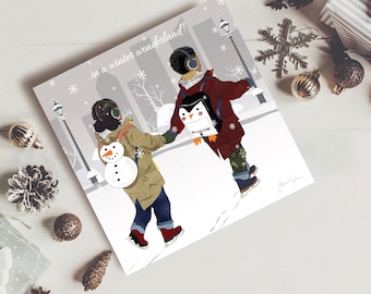 May include: Two children, one wearing a red jacket and the other wearing a brown jacket, are ice skating on a snowy day. They are holding hands and smiling. The text "...in a winter wonderland!" is written at the top of the card.