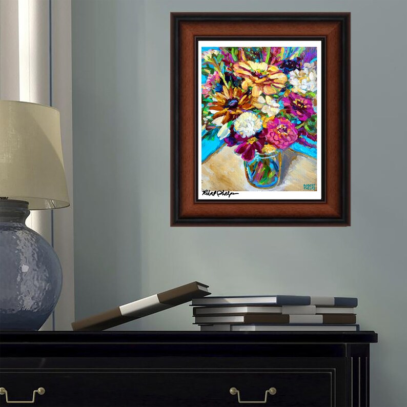May include: A framed painting of a colorful bouquet of flowers in a glass jar. The flowers are mostly pink, purple, and yellow, with some white and orange accents. The background is a light blue color.
