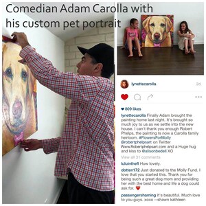 May include: A man hangs a custom pet portrait of a dog on a wall. The painting is in a colorful, impressionistic style. The caption reads "Finally Adam brought the painting home last night. It's brought so much joy to us as we settle into the new house. I can't thank you enough Robert Phelps, the painting is now a Carolla family heirloom. #FlowersForMolly @robertphelpsart on Twitter Www.Robertphelpsart.com and a Huge hug and kiss to @alisonbedell XO"