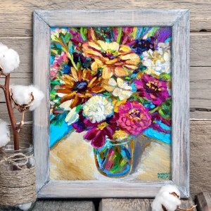 May include: A painting of a colorful bouquet of flowers in a glass jar. The flowers are mostly pink, yellow, and white, with some green leaves. The jar is clear glass and has a blue and green pattern. The painting is signed "Robert Phelps" in the bottom right corner.