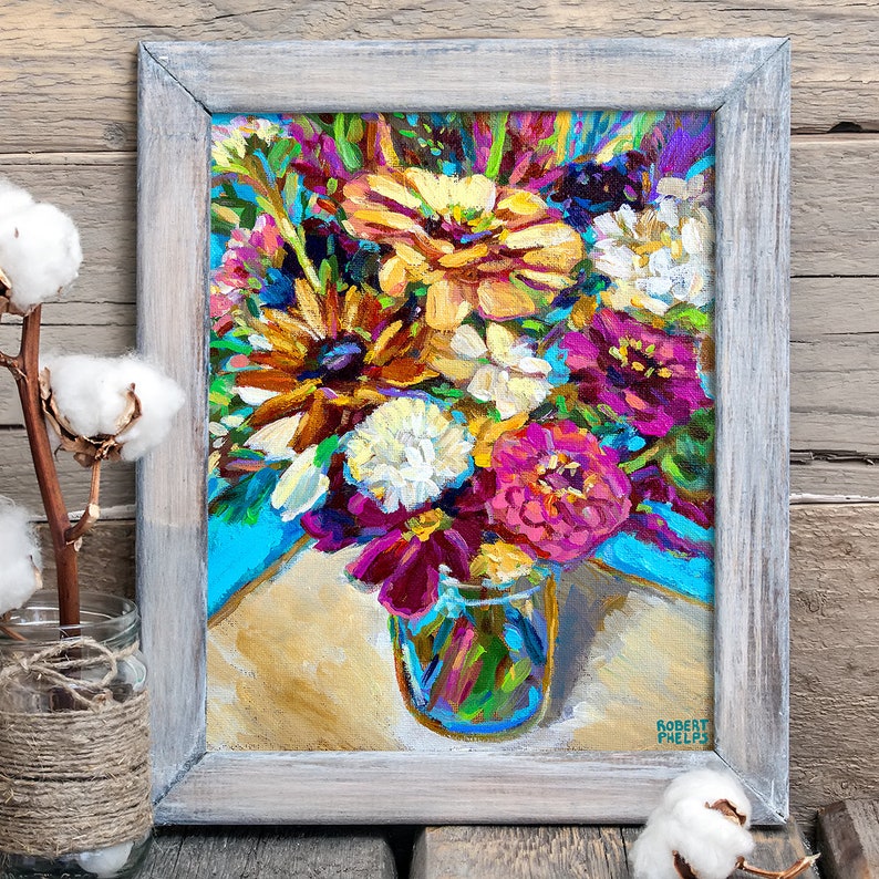 May include: A painting of a colorful bouquet of flowers in a glass jar. The flowers are mostly pink, yellow, and white, with some green leaves. The jar is clear glass and has a blue and green pattern. The painting is signed "Robert Phelps" in the bottom right corner.