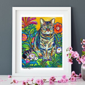 May include: A colorful painting of a tabby cat sitting in a garden with flowers. The cat is surrounded by bright green leaves and flowers in shades of pink, red, orange, and yellow. The artist's signature, "Robert Phelps", is visible in the bottom left corner.