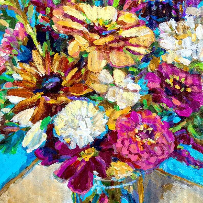 May include: A close-up of a bouquet of colorful flowers in a vase. The flowers are a mix of pink, purple, white, yellow, and orange. The vase is a clear glass with a blue and green pattern.