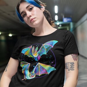 May include: Black t-shirt with a colorful graphic of two bats flying in a circle with a galaxy background.