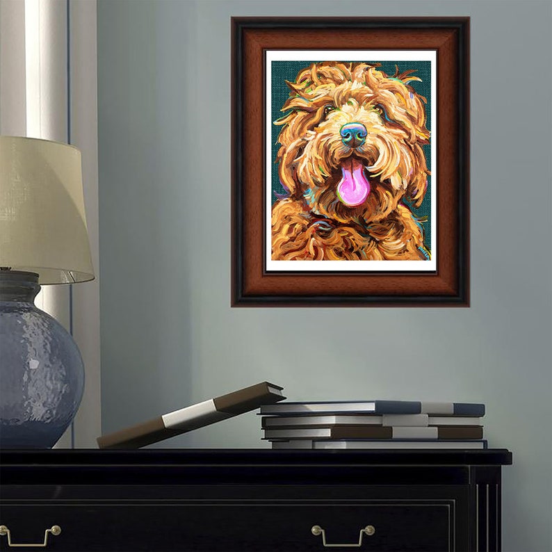 May include: A framed painting of a brown dog with its tongue sticking out. The dog has a happy expression and is painted in a colorful style.