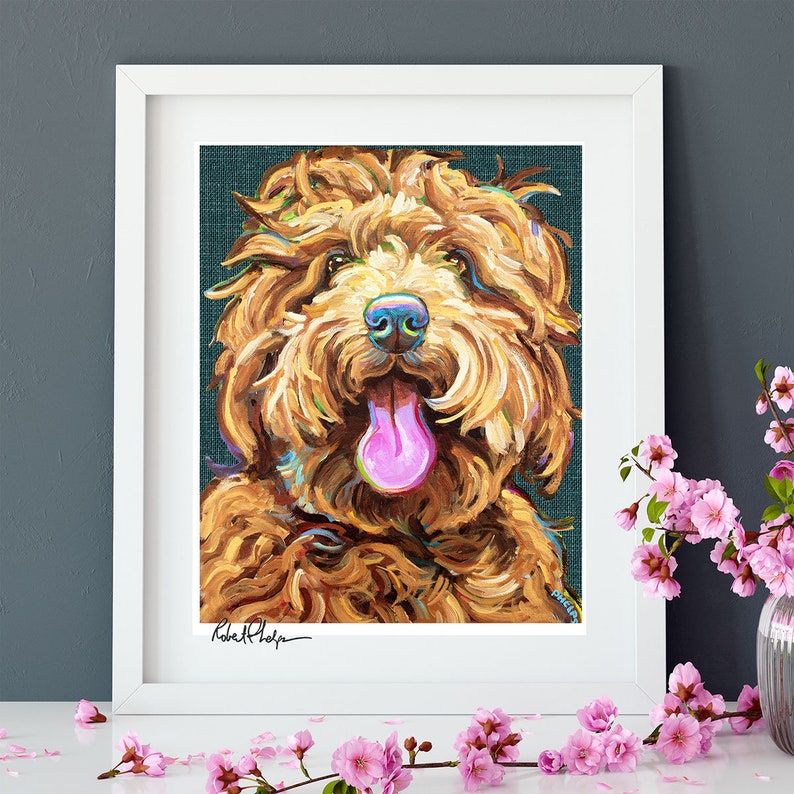 May include: A painting of a brown and white dog with its tongue sticking out. The dog is painted in a colorful style with a teal background. The painting is signed "Robert Phelps".