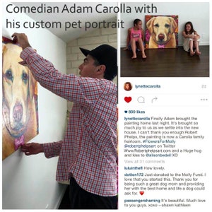 May include: A man hangs a custom pet portrait of a dog on a wall. The painting is in a colorful, impressionistic style. The caption reads "Finally Adam brought the painting home last night. It's brought so much joy to us as we settle into the new house. I can't thank you enough Robert Phelps, the painting is now a Carolla family heirloom. #FlowersForMolly @robertphelpsart on Twitter Www.Robertphelpsart.com and a Huge hug and kiss to @alisonbedell XO"