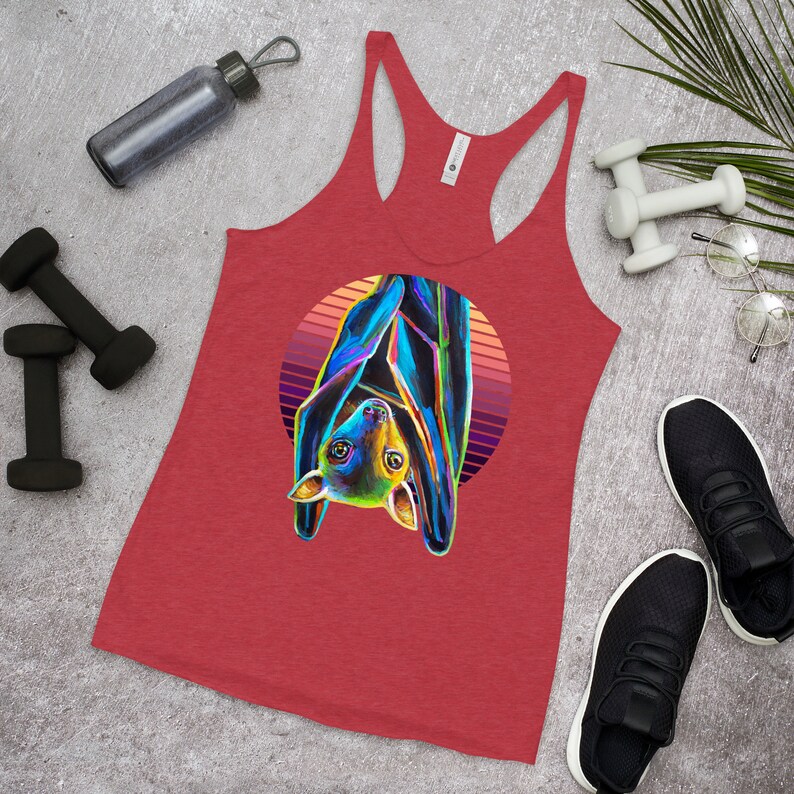 May include: Red tank top featuring a colourful illustration of a bat hanging upside down in a sunset circle.