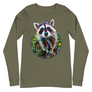 May include: Olive green long-sleeve shirt featuring a colorful raccoon illustration within a circular frame. The raccoon is depicted with vibrant brushstrokes, showcasing a mix of blues, browns, and whites. The design is centered on the shirt, offering a unique and artistic look.