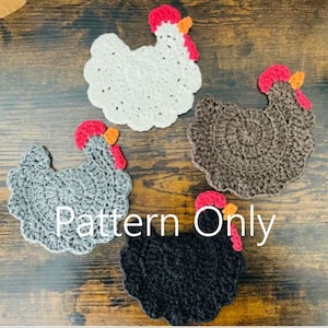 May include: Four crocheted chicken coasters in different colors: white, gray, brown, and black. Each coaster has a red comb and wattle, and orange eyes. The coasters are arranged on a wooden surface. Pattern Only.
