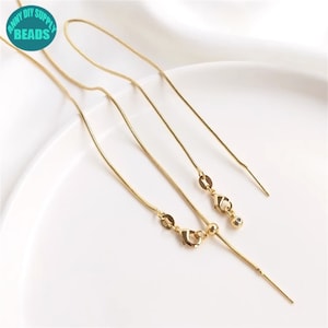 May include: Three gold snake chains with clasps and jump rings. The chains are different lengths.