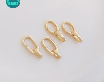 May include: Four gold-toned metal lobster clasps, each with a smooth, oval-shaped design. The clasps are arranged in a row on a white surface.