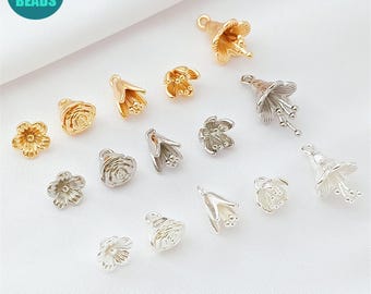 May include: A collection of gold and silver-colored flower-shaped beads. The beads vary in design, including rose and bell flower shapes. The image includes a teal circle with the text "ANNY DIY SUPPLY BEADS".