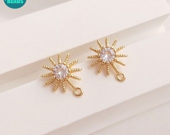 May include: Two gold-toned starburst charms with clear crystal centres and a jump ring for attaching to jewellery.