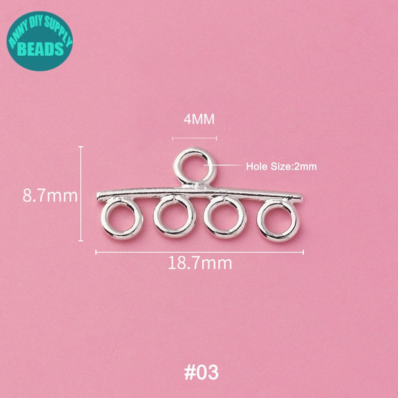 May include: Silver-toned metal connector with five loops, measuring 18.7 mm wide and 8.7 mm tall. The connector has a 4 mm loop at the top and a hole size of 2 mm. #03