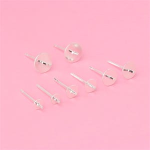 Peut inclure: Un ensemble de huit tiges d'oreille en argent avec des dos plats. Les tiges sont de différentes tailles.
