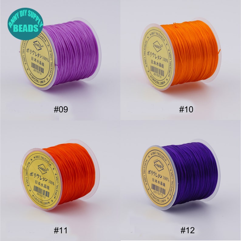 May include: Four spools of elastic string in different colours: purple, orange, orange, and purple. Each spool has a label that reads "ポリウレタン 100% 日本水晶线" and a number: #09, #10, #11, and #12.