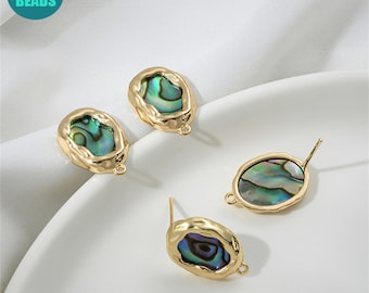 May include: Four gold-toned earring findings with oval-shaped abalone shell insets. The findings have a loop on one side and a post on the other.