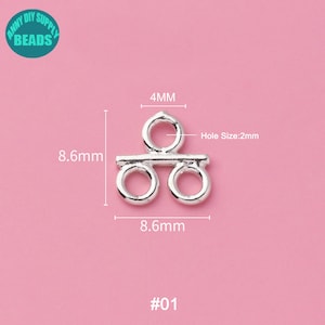 May include: Silver-toned metal connector with two loops and a bar in the middle. The connector measures 8.6 mm wide and 4 mm high. The hole size is 2 mm. #01