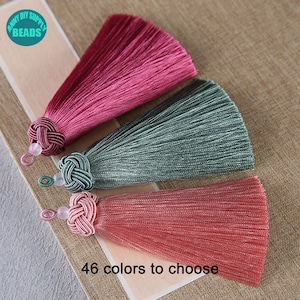 May include: Three silk tassels in pink, green, and red with a knotted top and a small bead at the end.  46 colours to choose from.