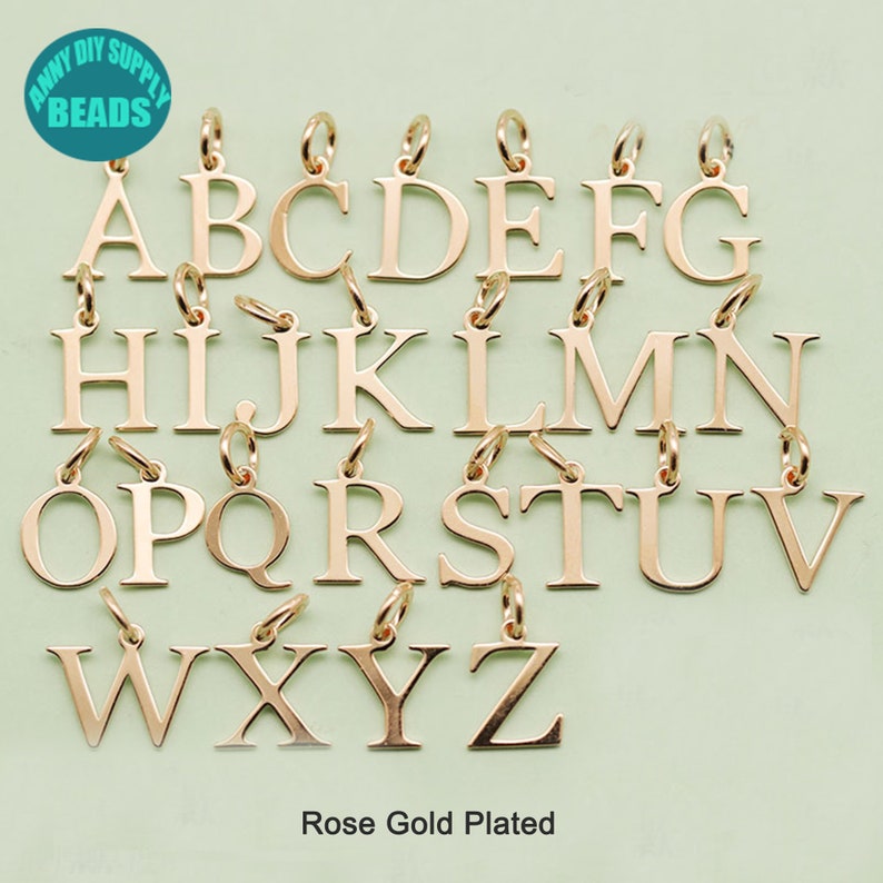 May include: Rose gold plated alphabet letter charms, A through Z. Each charm has a jump ring for attaching to jewelry.