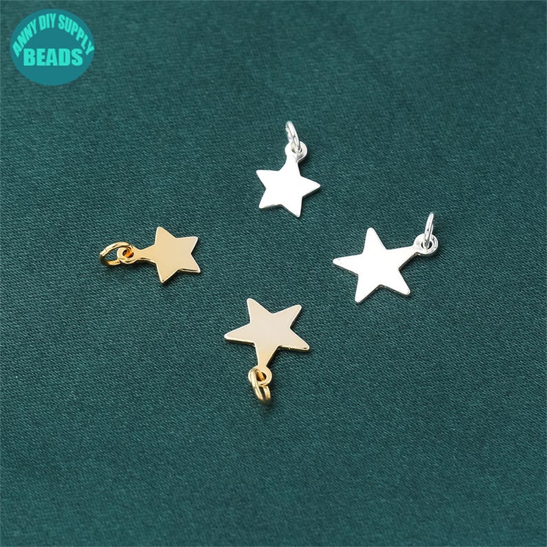 May include: Four star-shaped charms, two gold and two silver, with jump rings for attaching to jewelry or other crafts.