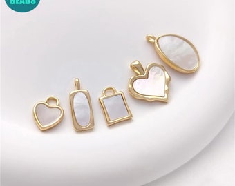 May include: Five gold-tone pendants with white mother-of-pearl inserts. The pendants are in the shapes of a heart, oval, square, and two different heart shapes.