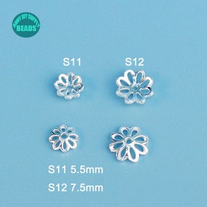 May include: Four silver-colored flower-shaped bead caps, two each of two sizes, against a light blue background. The smaller caps are 5.5mm, and the larger ones are 7.5mm. The text "ANNY DIY SUPPLY BEADS" is in a green circle in the upper left corner.