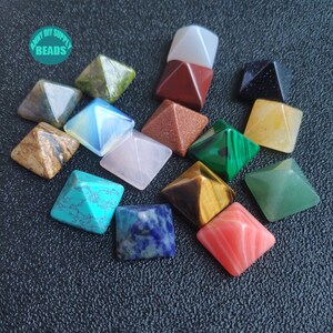 May include: Assortment of 15 small pyramid-shaped crystal stones in various colours, including green, blue, red, brown, yellow, white, and pink. The crystals are arranged on a black surface. "Anny DIY Supply Beads" is written in white text on a green circle.