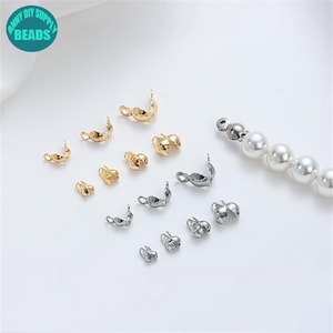 May include: Assortment of gold and silver metal bead caps for jewelry making. The caps are designed to cover the ends of a string of beads, creating a finished look.  The caps are available in a variety of sizes and styles.