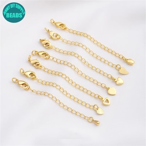 May include: Seven gold-toned extender chains with lobster claw clasps and heart-shaped charms. The chains are of varying lengths and the charms are of different sizes.