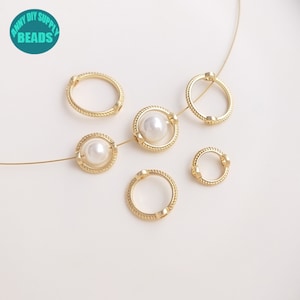 May include: Six gold-toned metal bead caps with a rope-like design. Two of the caps have a white pearl bead in the centre.