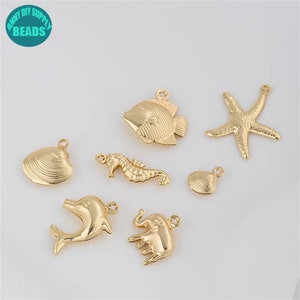 May include: Gold-toned metal charms in the shape of a starfish, seashell, fish, dolphin, seahorse, and elephant. These charms are perfect for jewelry making or crafting.