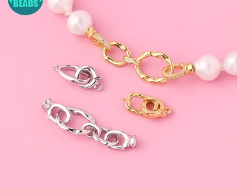 May include: Three silver and gold clasps for jewellery making. The clasps are in different styles, including a lobster clasp, a toggle clasp, and a chain clasp. The clasps are on a pink background.