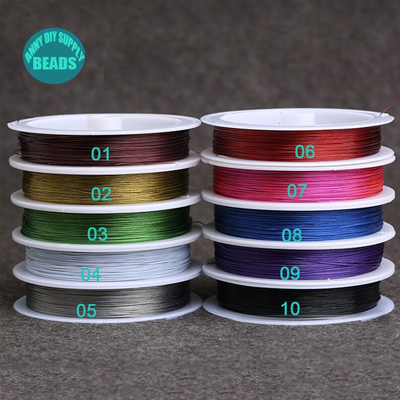 May include: Ten spools of colorful elastic cord, each wound around a white plastic spool. The spools are labeled with numbers 01 through 10.
