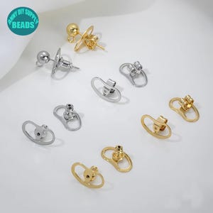 Pode incluir: Um conjunto de fechos para brincos em tons de prata e ouro. Os fechos são projetados para serem seguros e confortáveis de usar. São perfeitos para adicionar um toque de elegância a qualquer brinco.