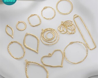 May include: A collection of 13 gold-toned metal jewelry making blanks in various shapes, including circles, ovals, hearts, and leaves. The blanks have a textured surface and are ready to be used for crafting.