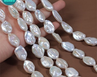 May include: A strand of white baroque freshwater pearls, with a slightly irregular shape, strung on a white thread. The pearls are approximately 10-12mm in size.