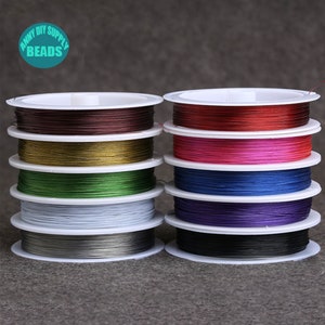 May include: Eight spools of colorful elastic cord for jewelry making. The colors are brown, gold, green, white, gray, red, pink, and blue.